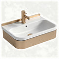 Ceramic sink with gold faucet and textured beige base 60 x 40 x 15cm